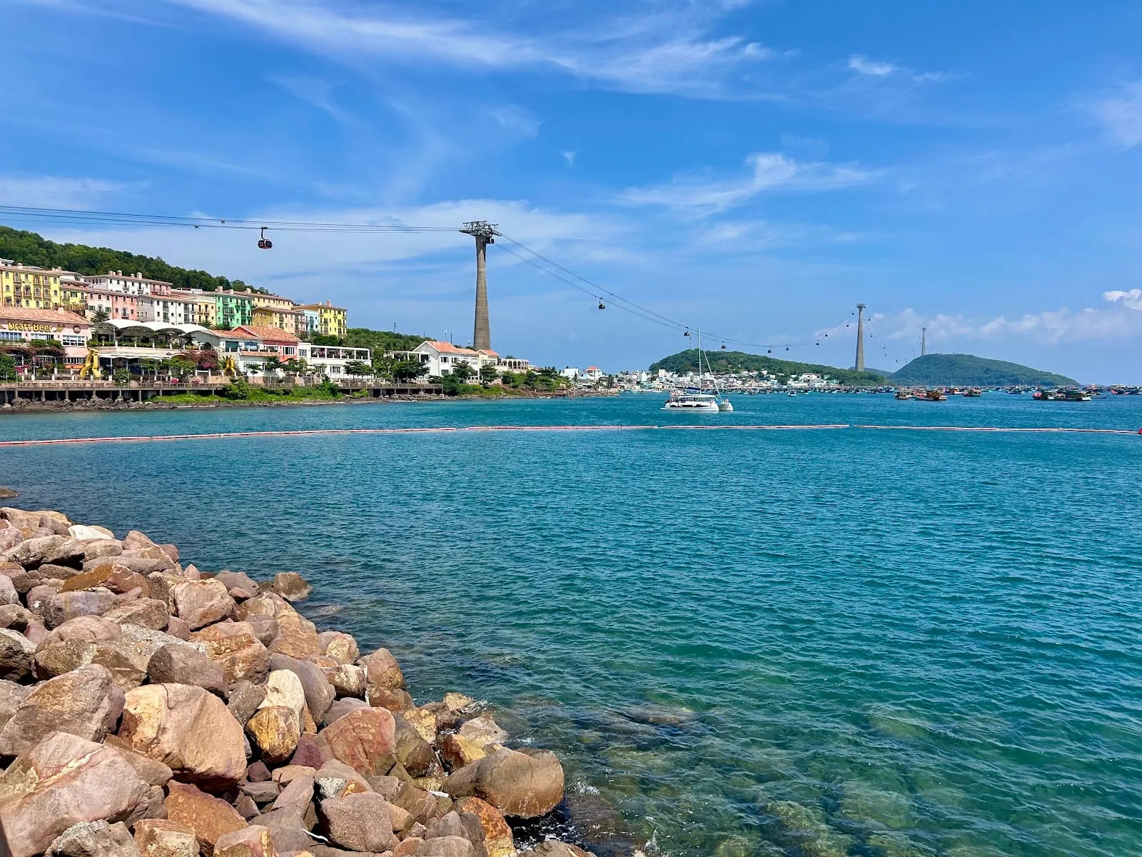 The bay at An Thoi with the colourful buildings of Sunset Town and the Hon Thom cable car overhead