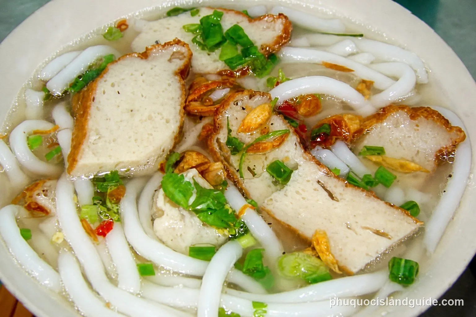 Bowl of bánh canh with thick noodles and fish cake