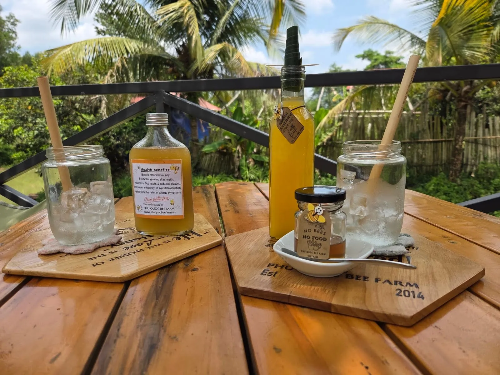 Honey drinks and bottles of honey on a wooden table in the bee farm café