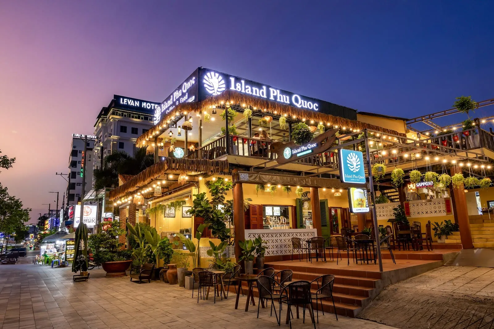 Island Phu Quoc café on Tran Hung Dao Street lit up at dusk