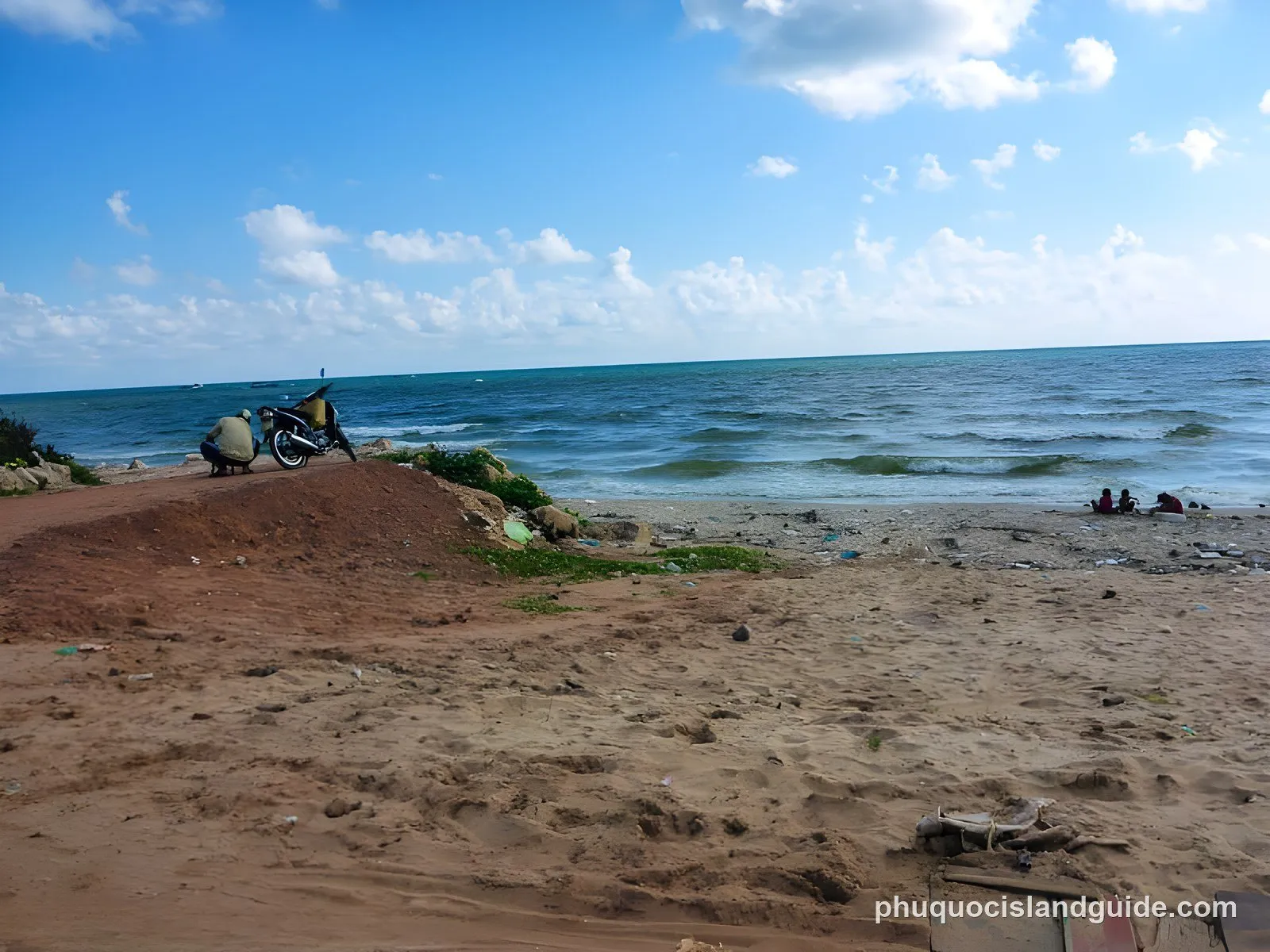 Sandy beach at Duong Dong with fishing boats in the distance