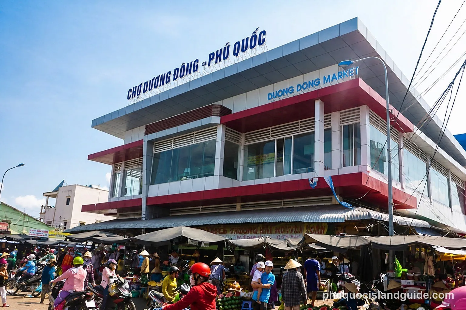 Crowded street market in Duong Dong with people and motorbikes