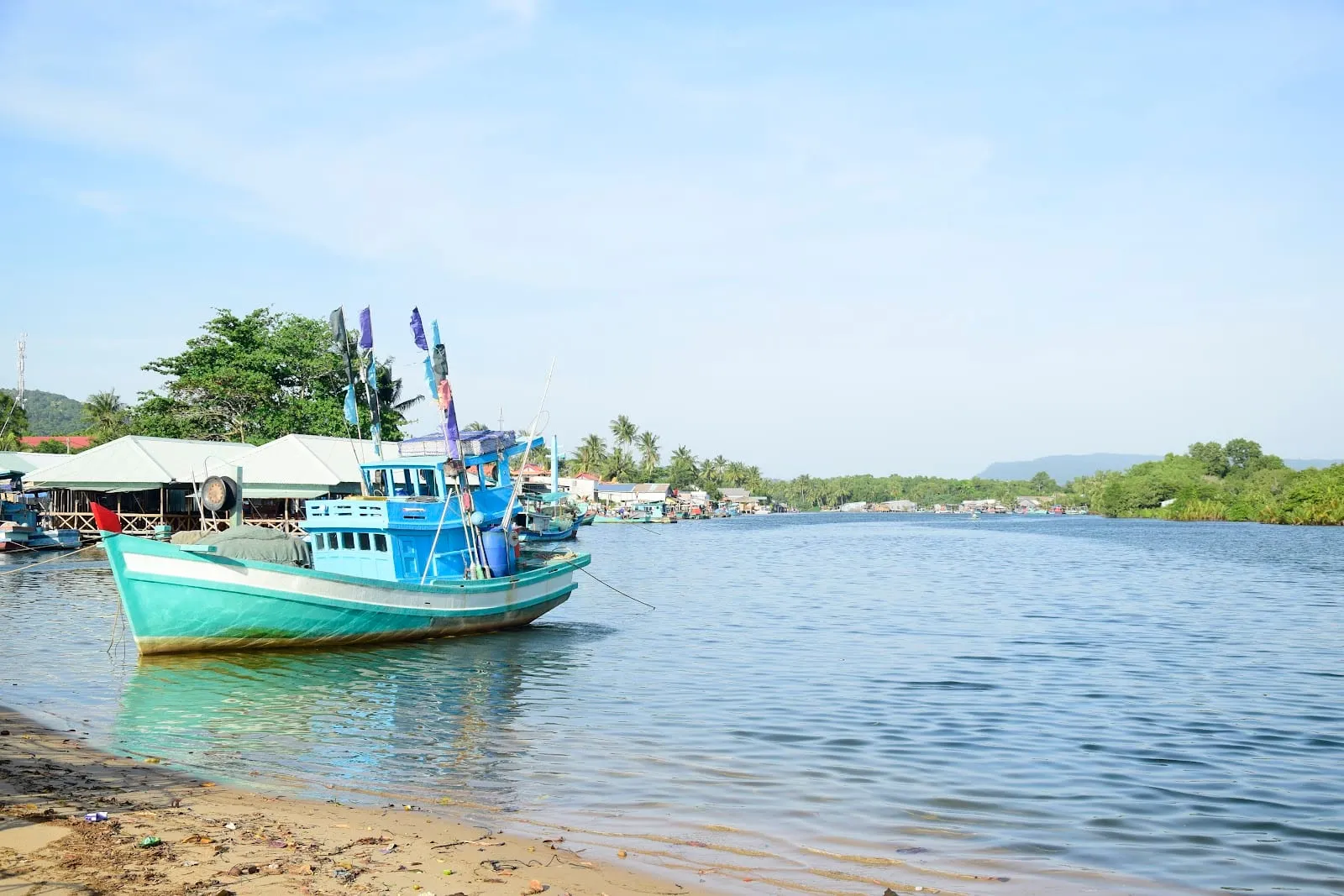 Fishing boats moored in the Cua Can river by the village