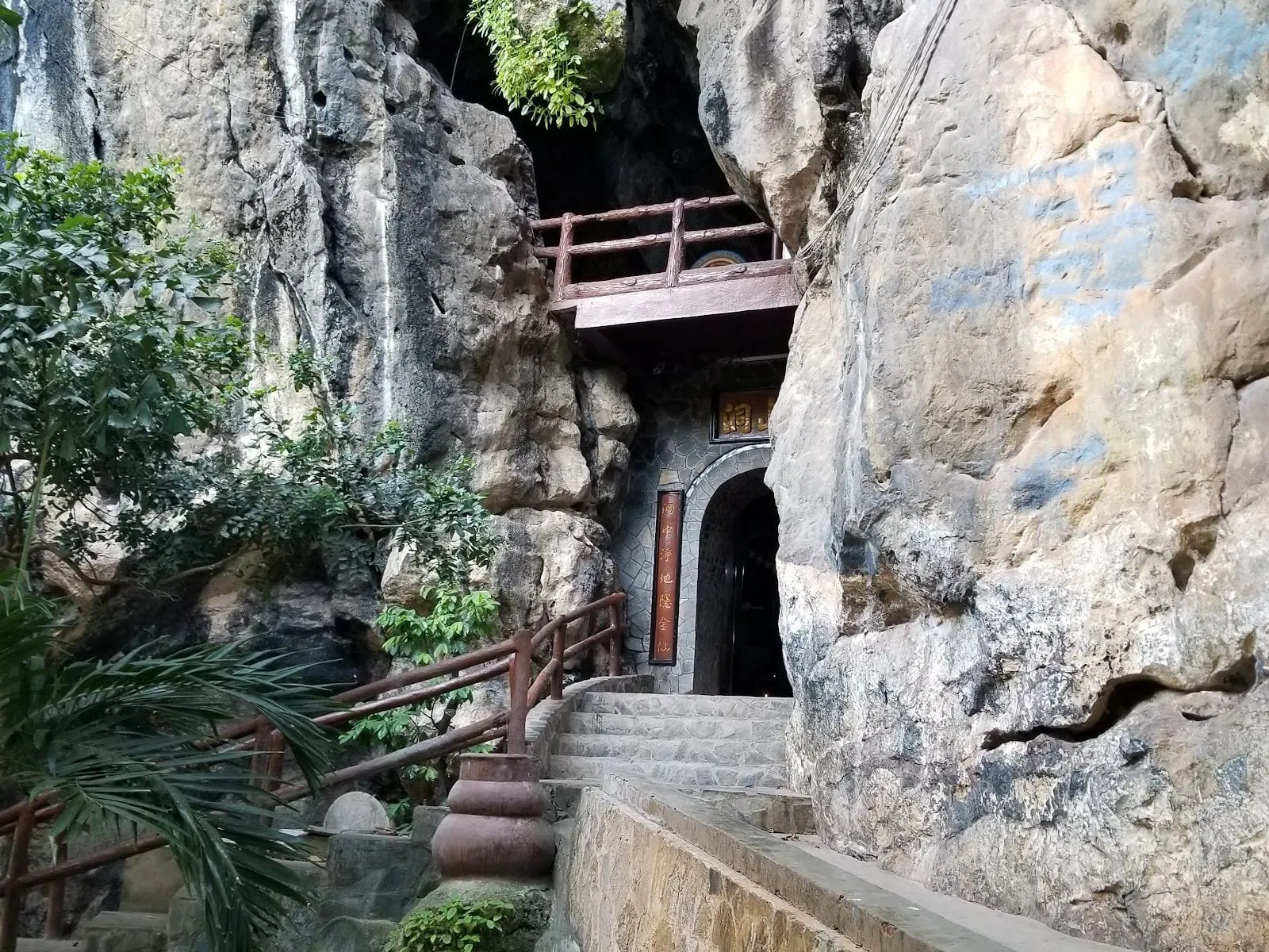 The entrance to a cave shrine set into the limestone cliffs of Thach Dong