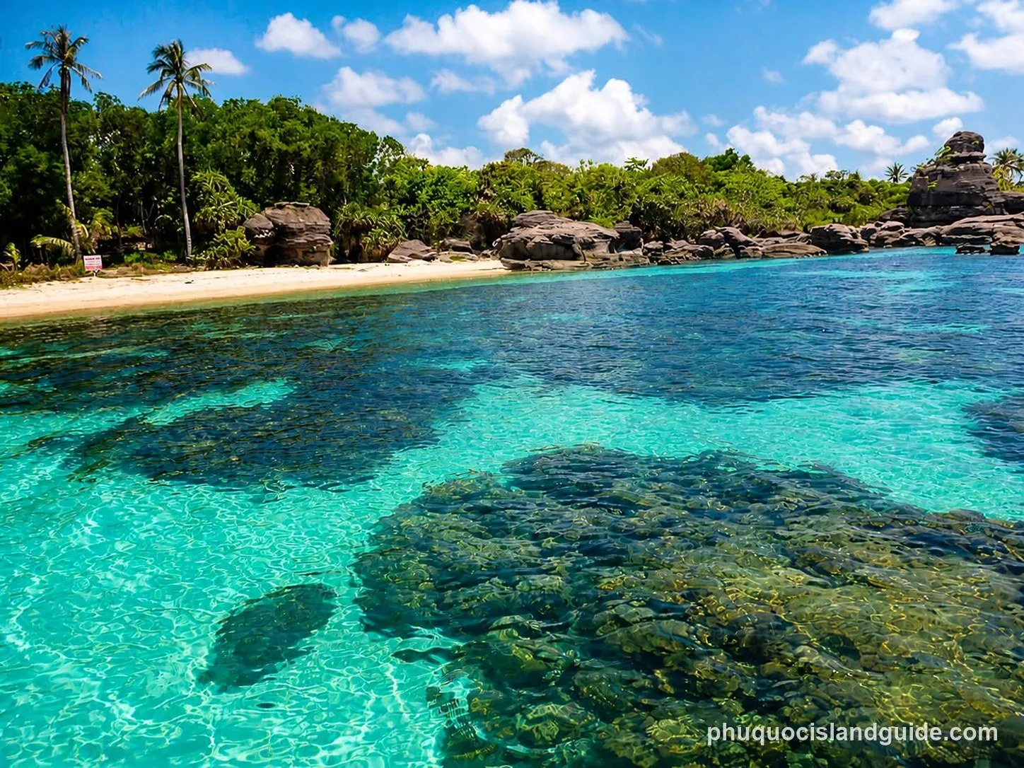 Clear turquoise water over coral and rocks at Hon Gam Ghi