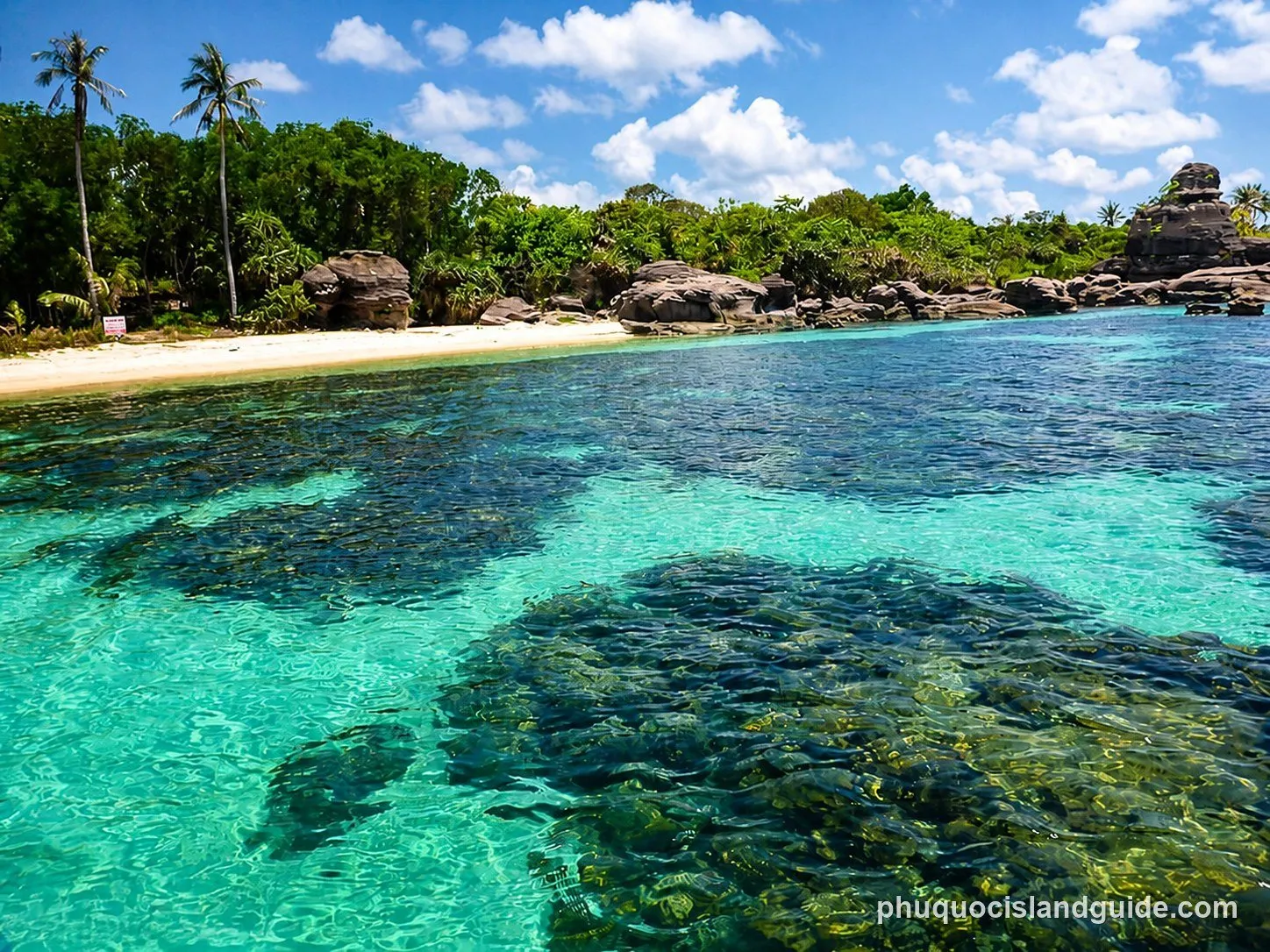 Clear turquoise water over coral and rocks at Hon Gam Ghi