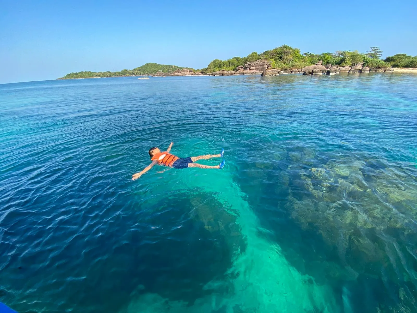 A snorkeller floating over the reef off Hon Mong Tay