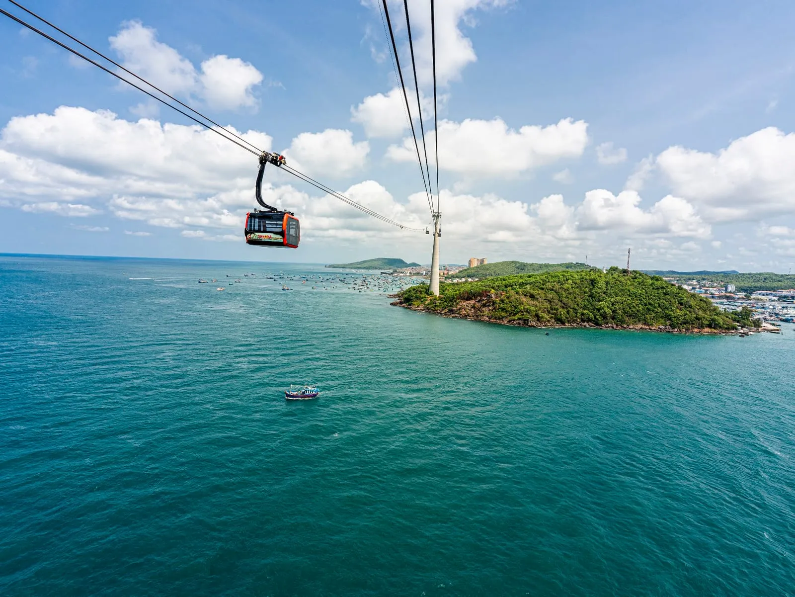 A cable car cabin over the sea with Hon Thom island behind