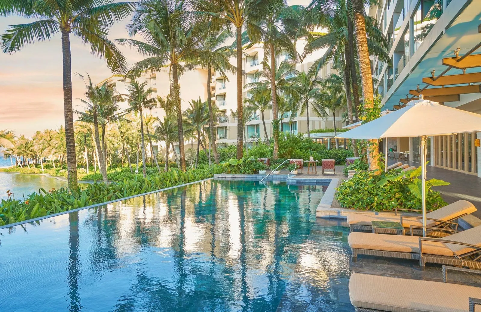 Infinity pool lined with palm trees at InterContinental Phu Quoc Long Beach Resort