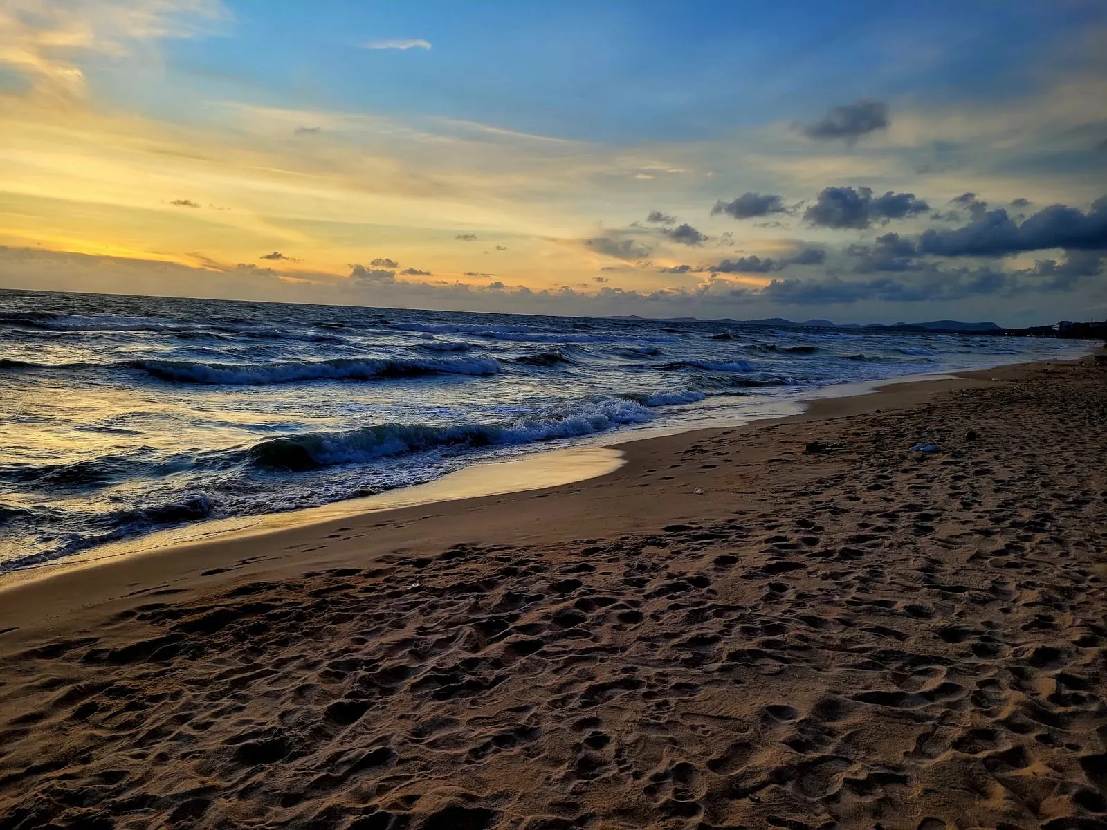 Waves on the sand at Long Beach at sunset