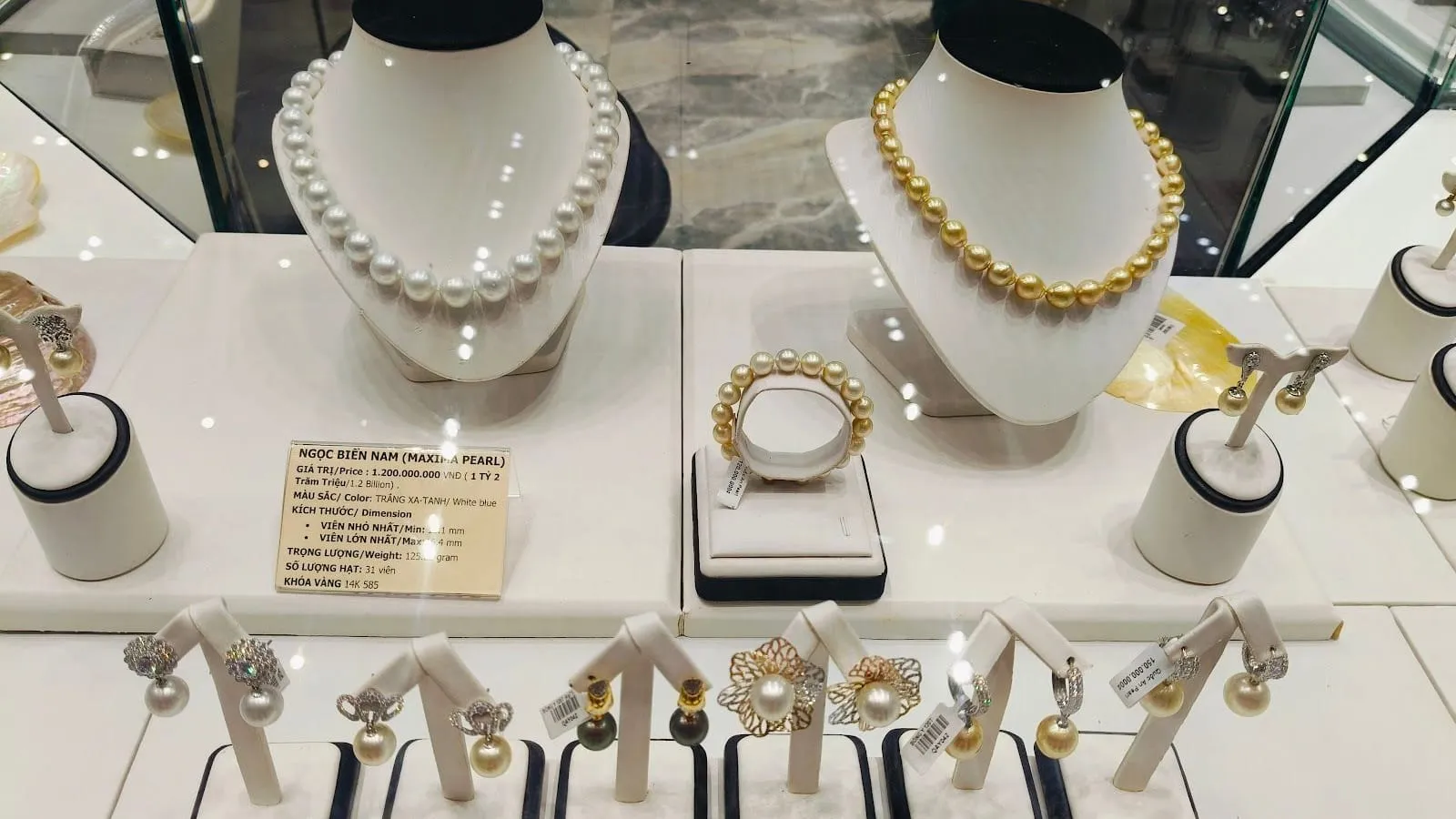 White and golden South Sea pearl necklaces and earrings displayed in a pearl showroom on Phu Quoc