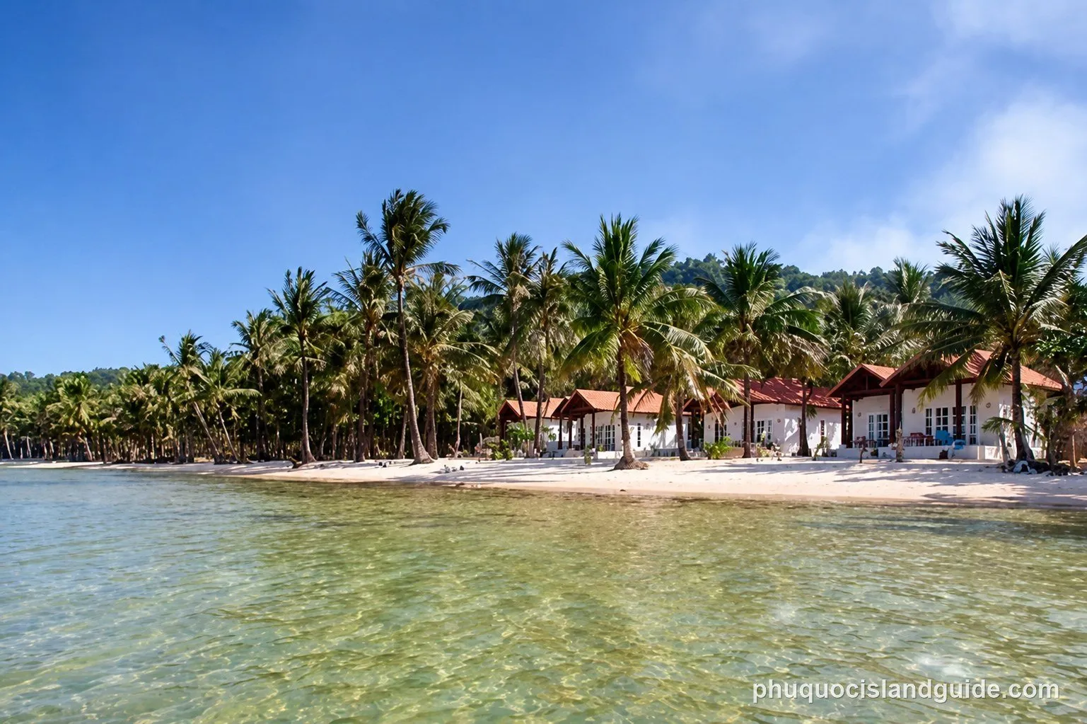 White sand beach with palm trees and bungalows near Ganh Dau