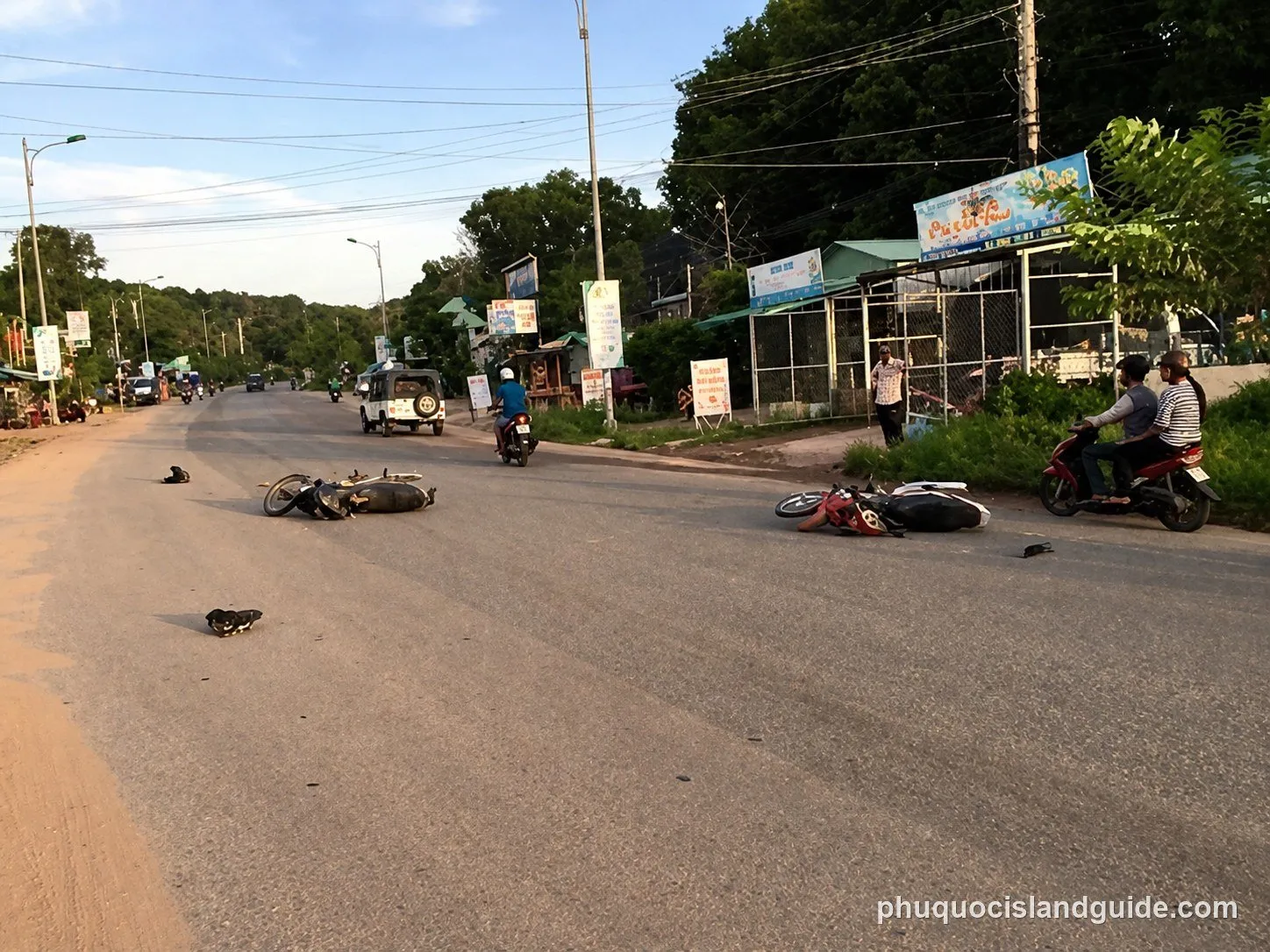 Two fallen motorbikes on a road after a minor accident