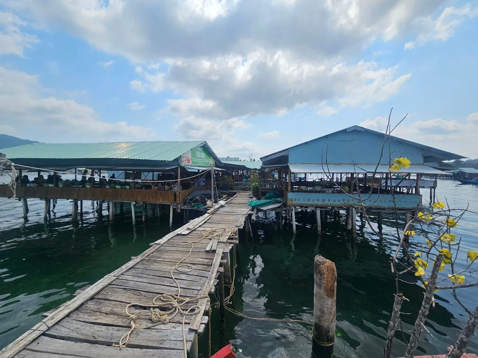 The long wooden dock out to Thu Bao stilt restaurant at Rach Vem