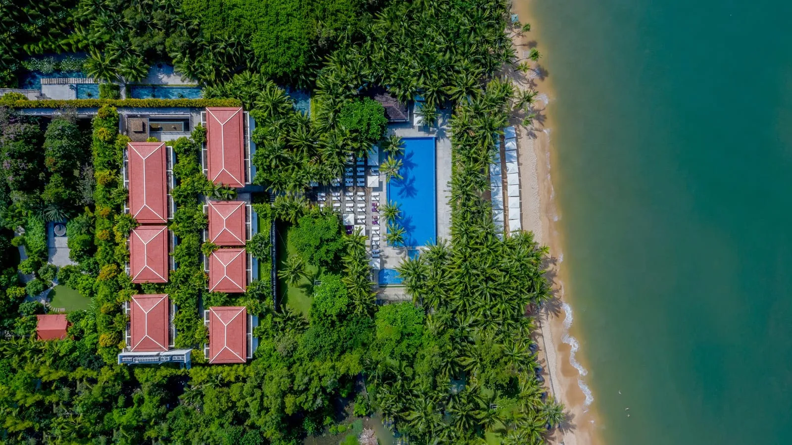 Aerial view of Salinda Resort’s red-roofed villas and beach