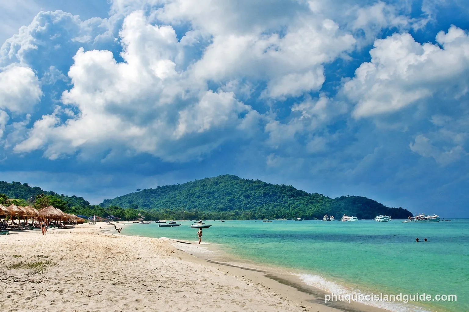 White sand and turquoise water at Sao Beach, with boats offshore