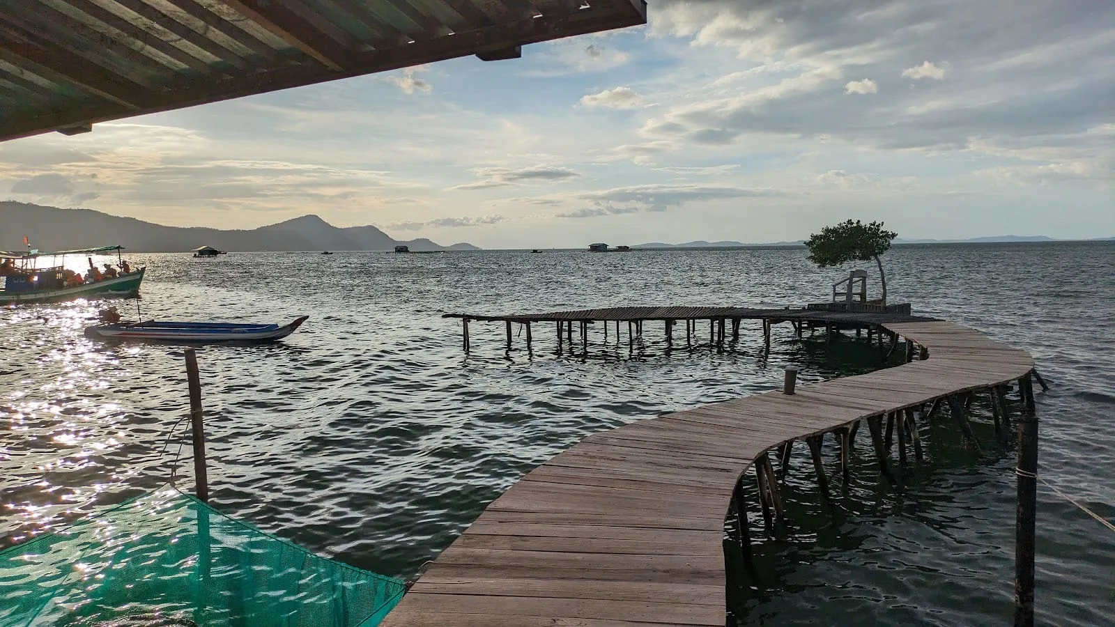 A wooden walkway leading out over the sea to the floating restaurants at Ham Ninh