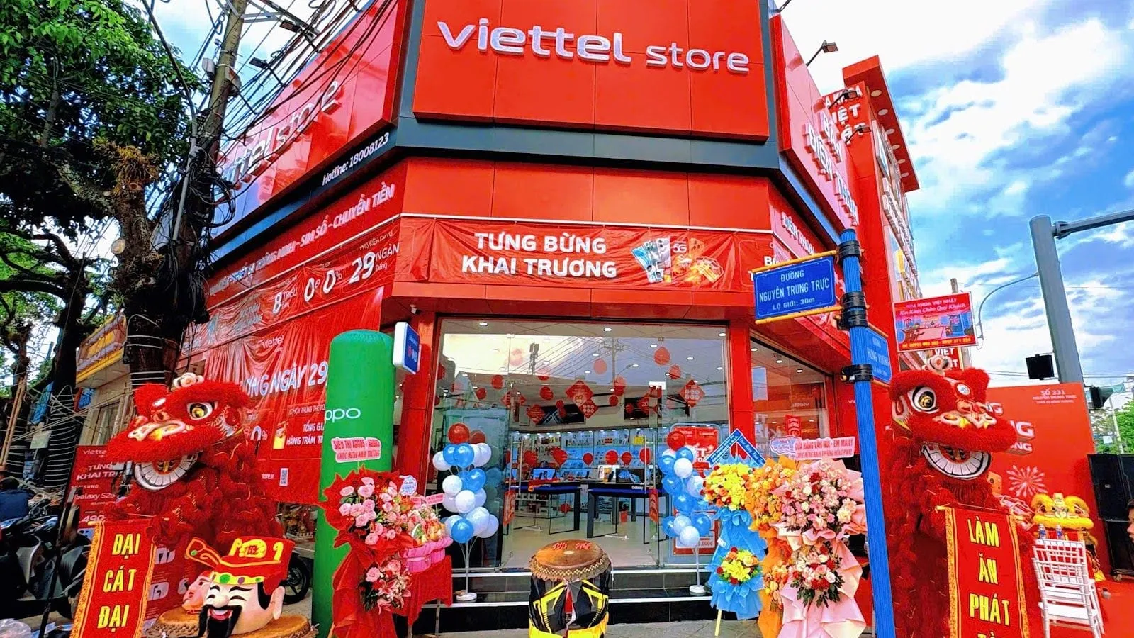 The red front of a Viettel Store mobile phone shop on a street corner in Duong Dong, decorated for its opening