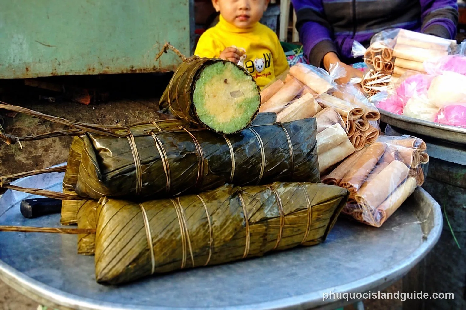 Bánh tét sticky rice cakes in banana leaves, one cut open