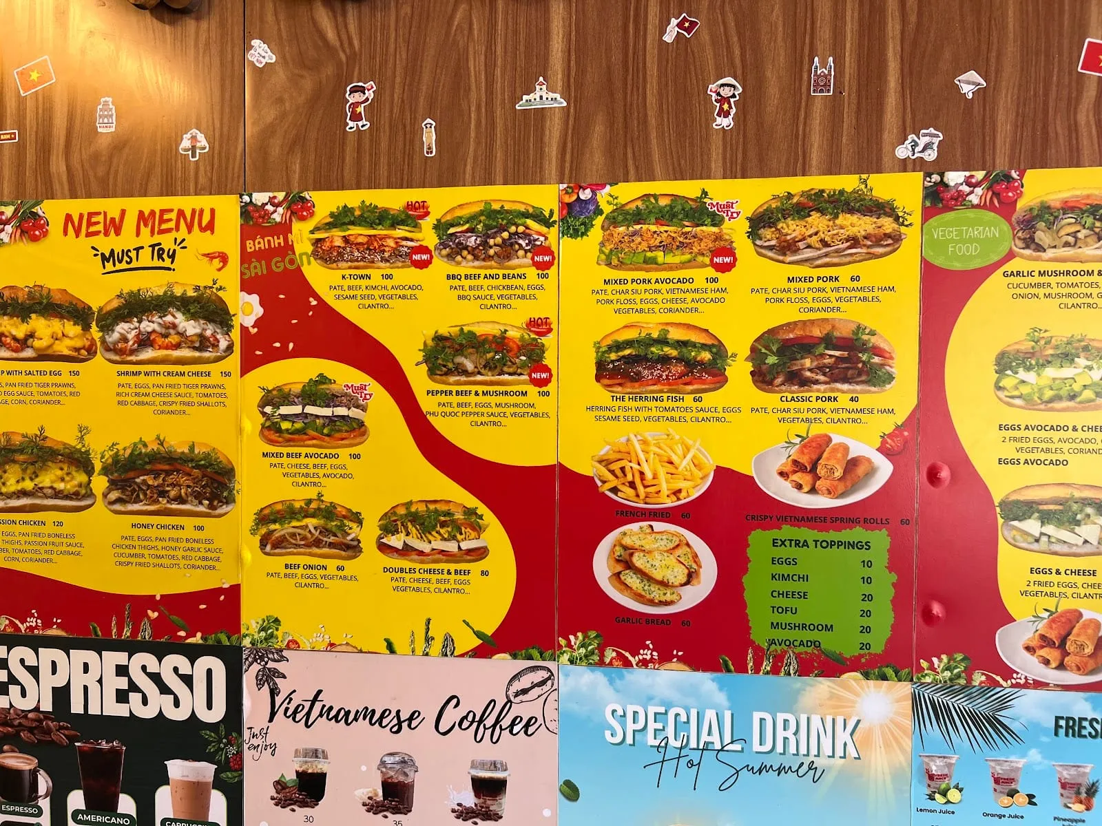 A wall menu at a banh mi shop on Phu Quoc listing sandwiches from 40 to 150 (thousand dong), with extra toppings at 10 to 20