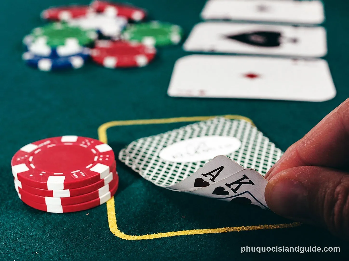 Ace and king of hearts on a casino table with chips