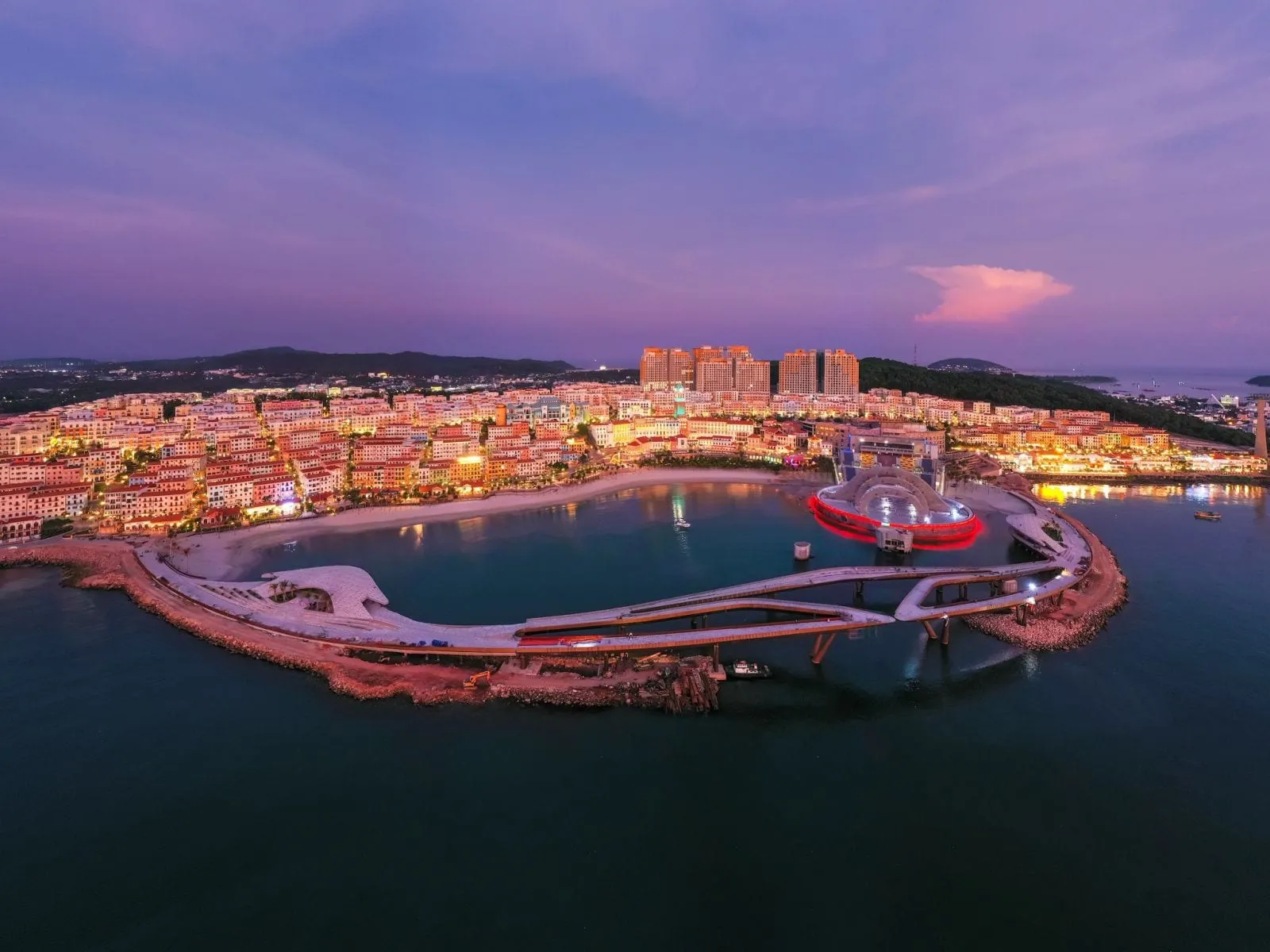 Aerial view of Sunset Town and its seafront at dusk